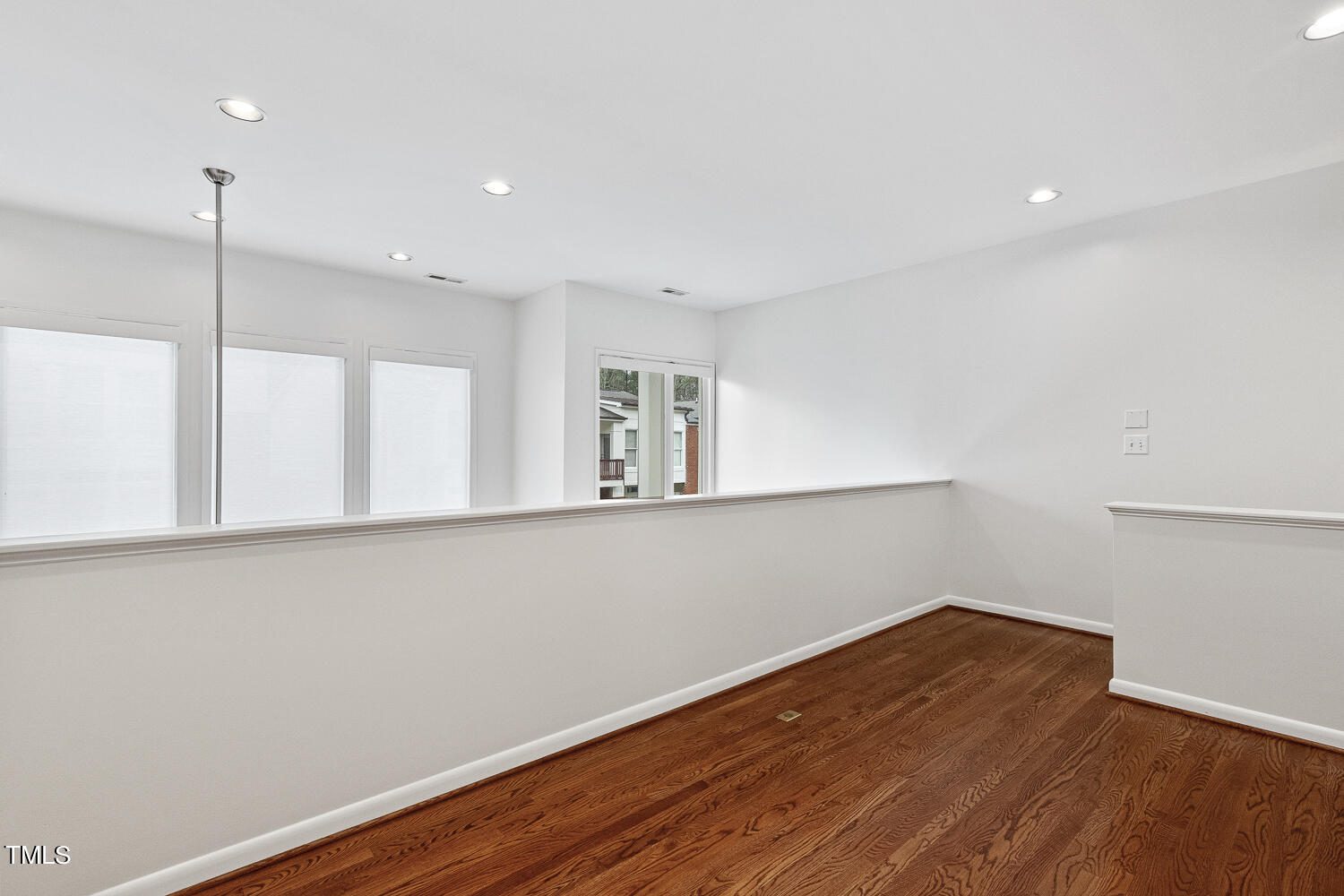 805 The Village Circle Raleigh, NC 27615 - Photo 26 of 42 a view of an empty room with wooden floor and a window