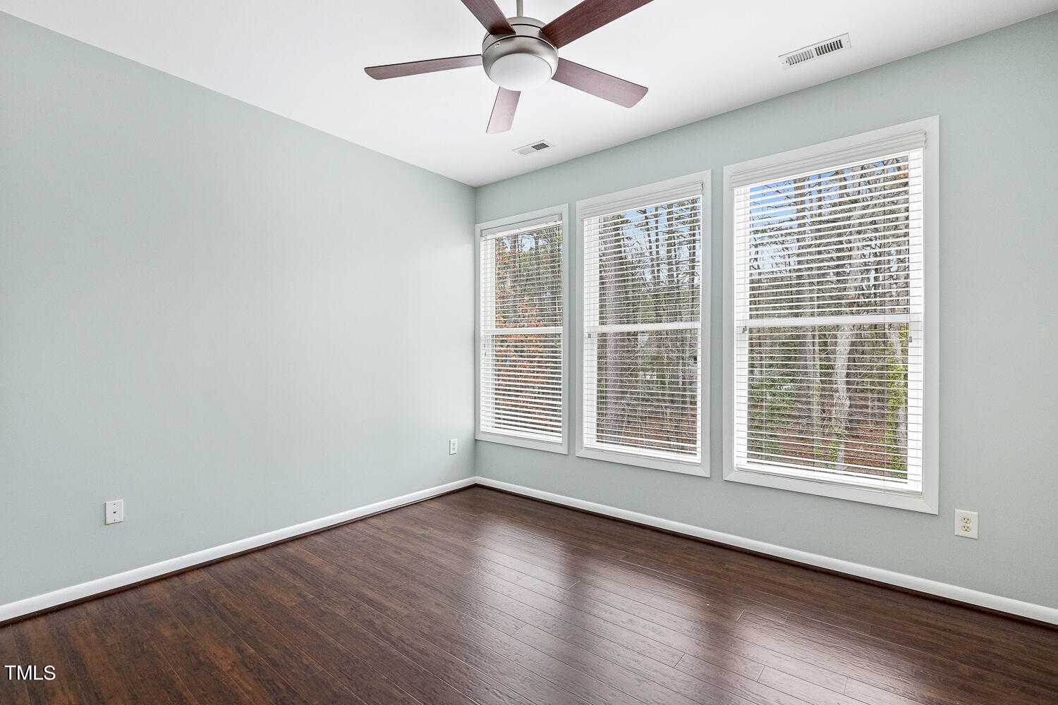 805 The Village Circle Raleigh, NC 27615 - Photo 28 of 42 a view of an empty room with wooden floor and a window