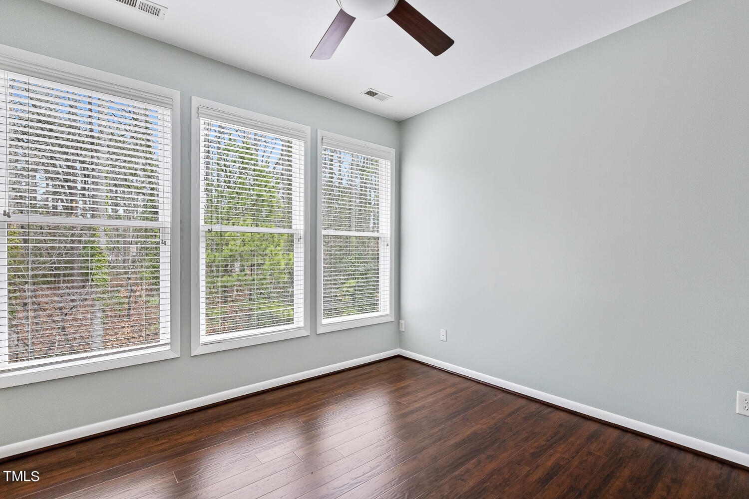 805 The Village Circle Raleigh, NC 27615 - Photo 30 of 42 a view of an empty room with wooden floor and a window