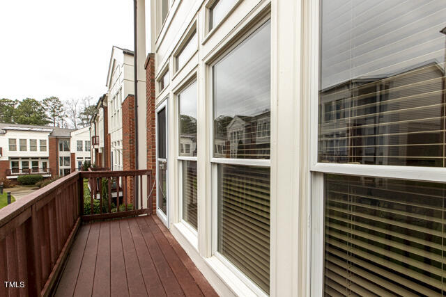 805 The Village Circle Raleigh, NC 27615 - Photo 35 of 42 a view of a balcony with wooden floor and fence