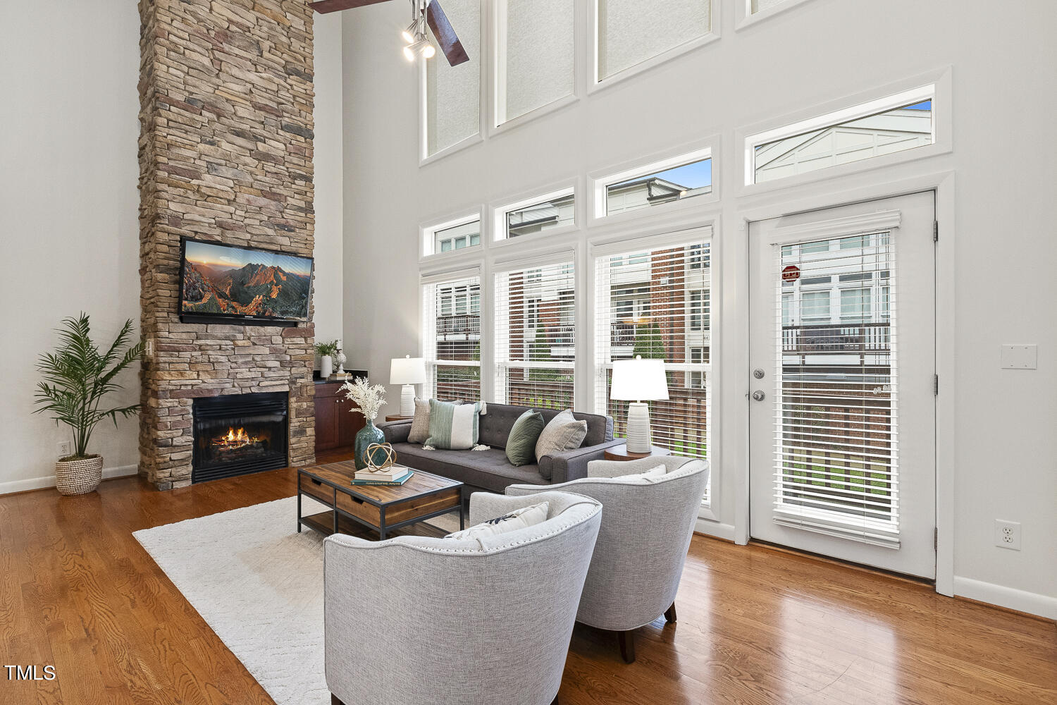 805 The Village Circle Raleigh, NC 27615 - Photo 6 of 42 a living room with fireplace furniture and a large window
