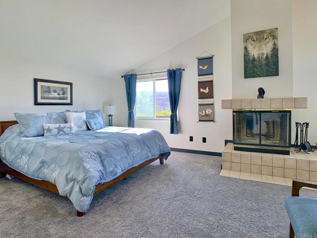 28743 Lebanon Road Pine Valley, CA 91962 - Photo 16 of 46 a spacious bedroom with a bed and a fireplace