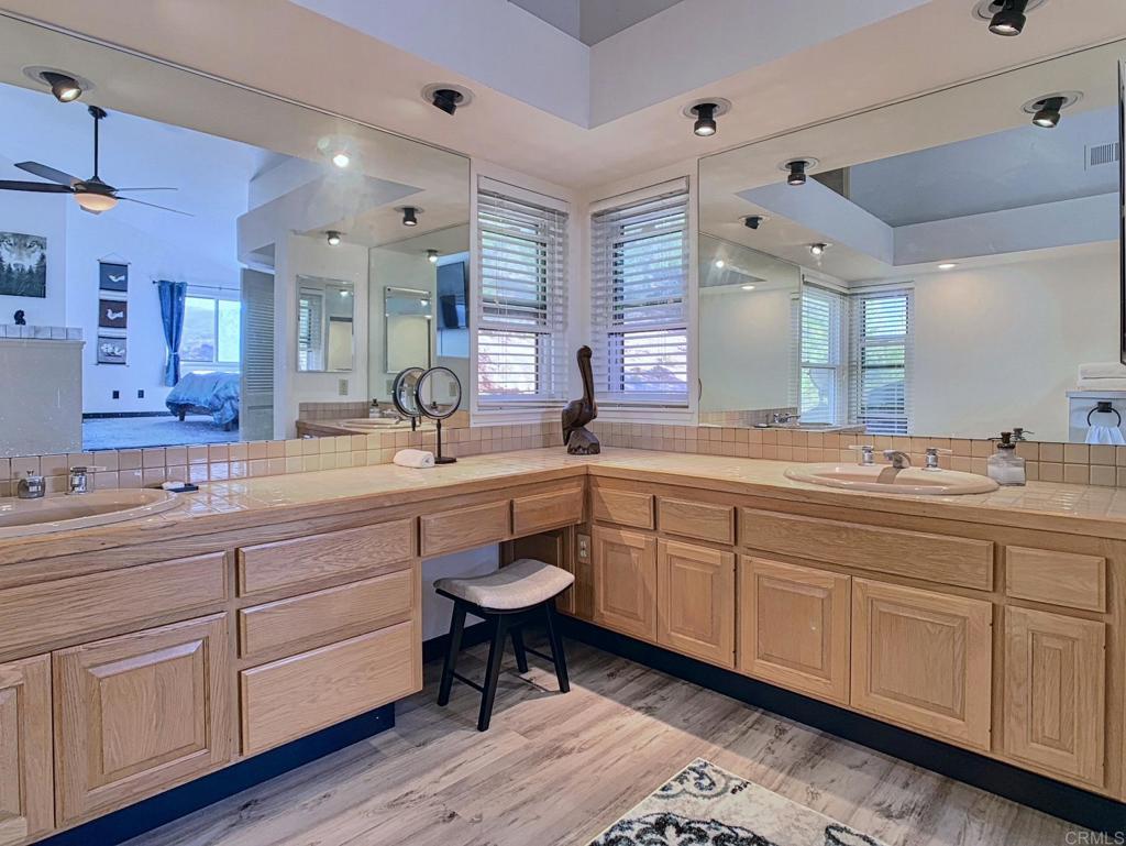 28743 Lebanon Road Pine Valley, CA 91962 - Photo 18 of 46 a bathroom with double vanity sink a two mirror a window a bathtub and vanity