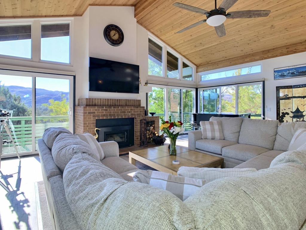 28743 Lebanon Road Pine Valley, CA 91962 - Photo 2 of 46 a living room with furniture a flat screen tv and a fireplace