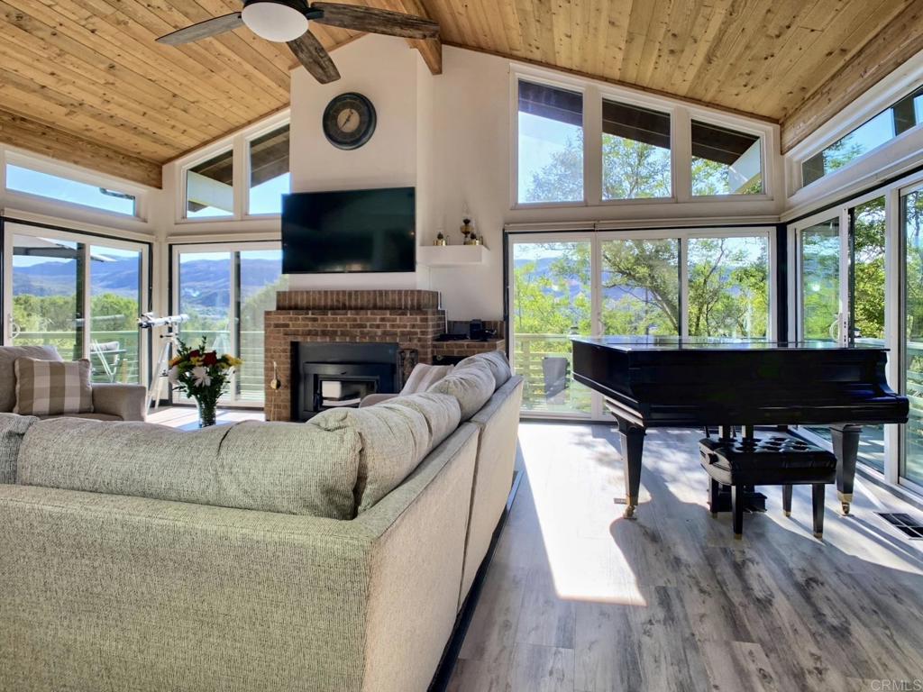 28743 Lebanon Road Pine Valley, CA 91962 - Photo 3 of 46 a living room with furniture a fireplace and a floor to ceiling window
