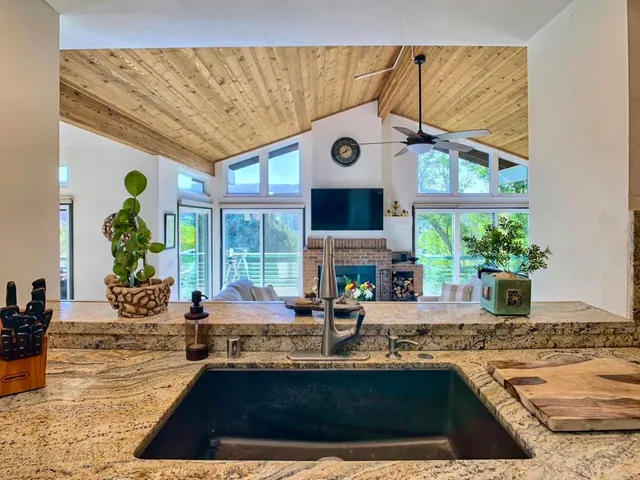 a kitchen with stainless steel appliances granite countertop a sink and a counter space