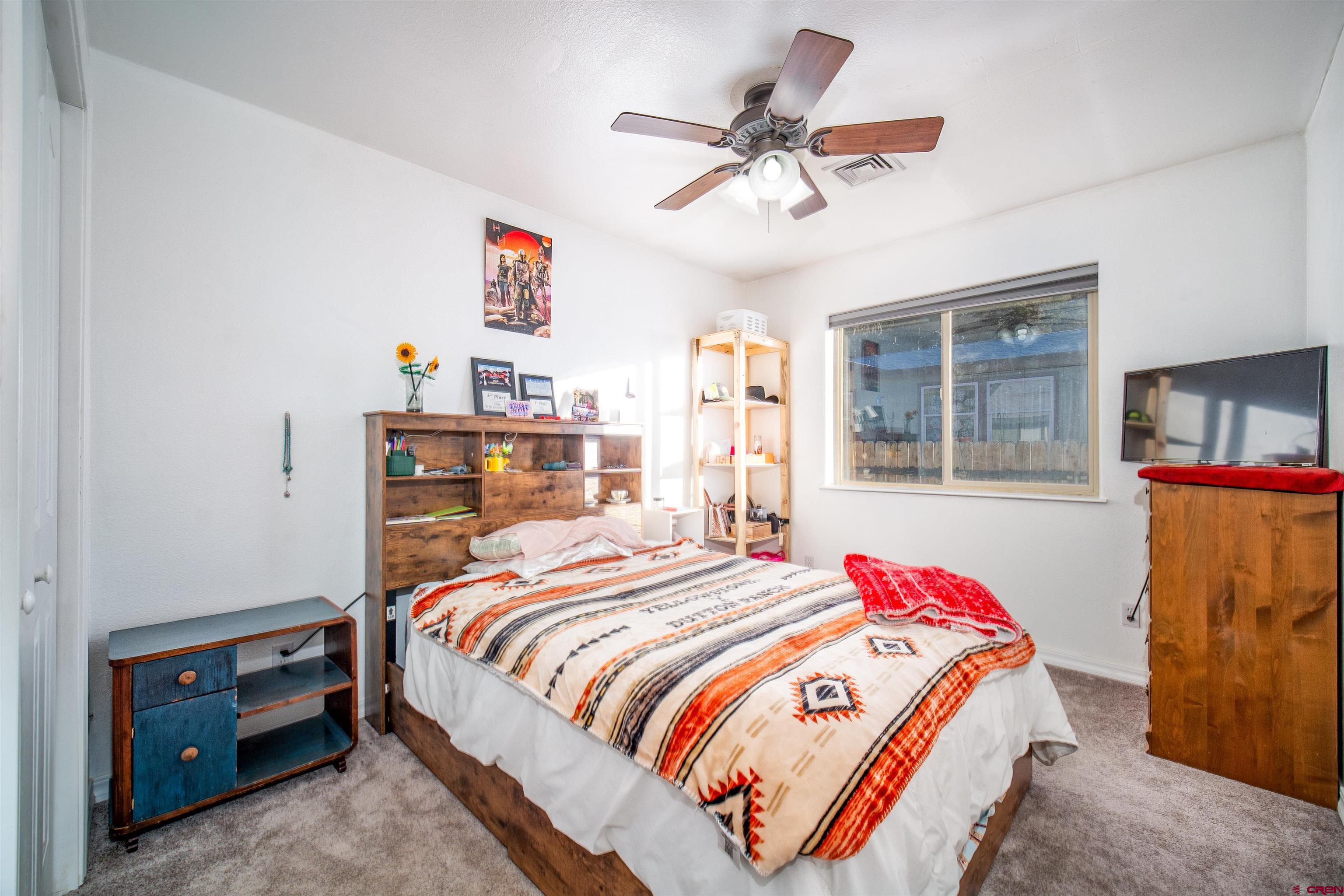 111 Meadowbrook Drive Bayfield, CO 81122 - Photo 14 of 30 a bedroom with a bed a dresser and a window