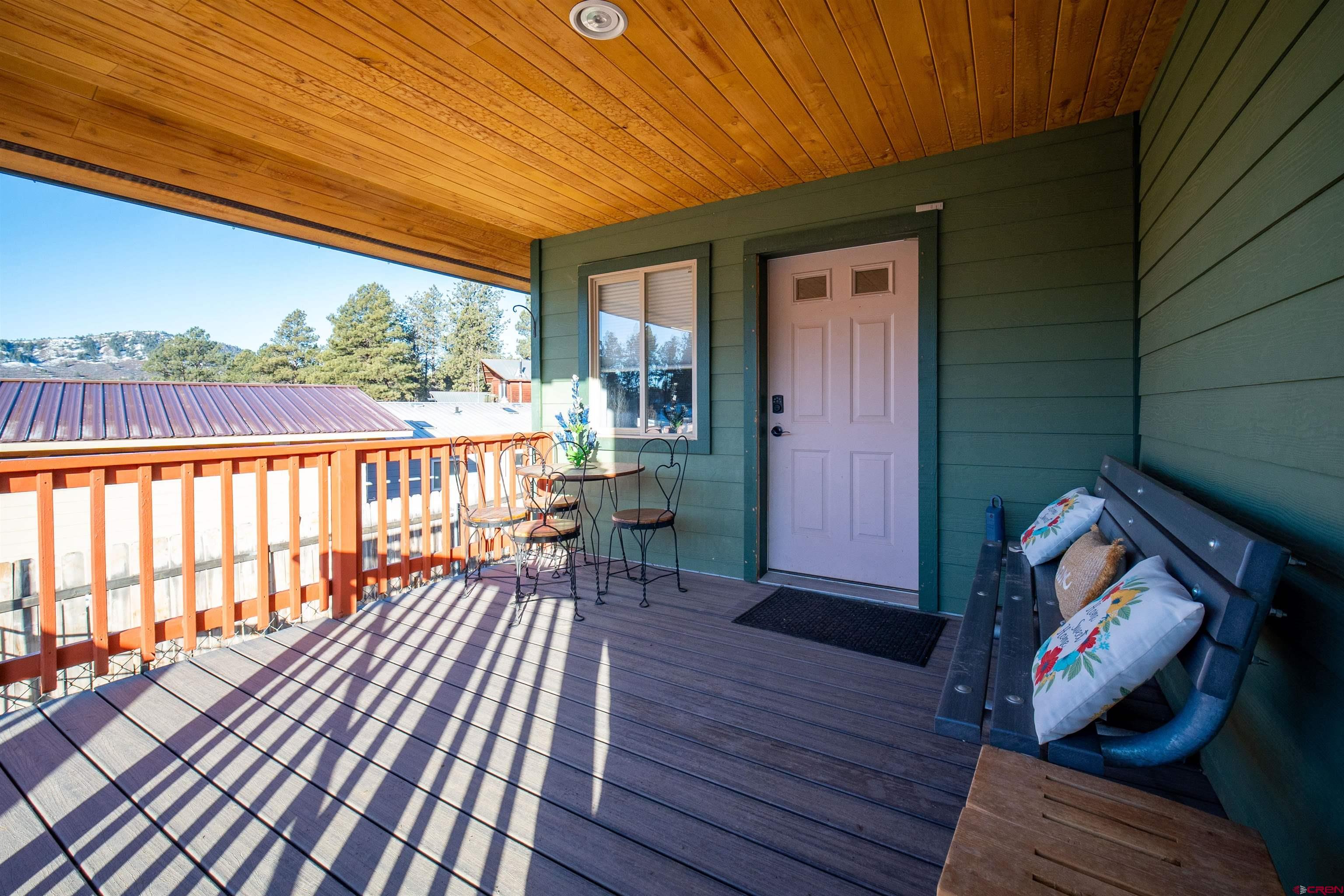 111 Meadowbrook Drive Bayfield, CO 81122 - Photo 27 of 30 a balcony with wooden floor table and chairs