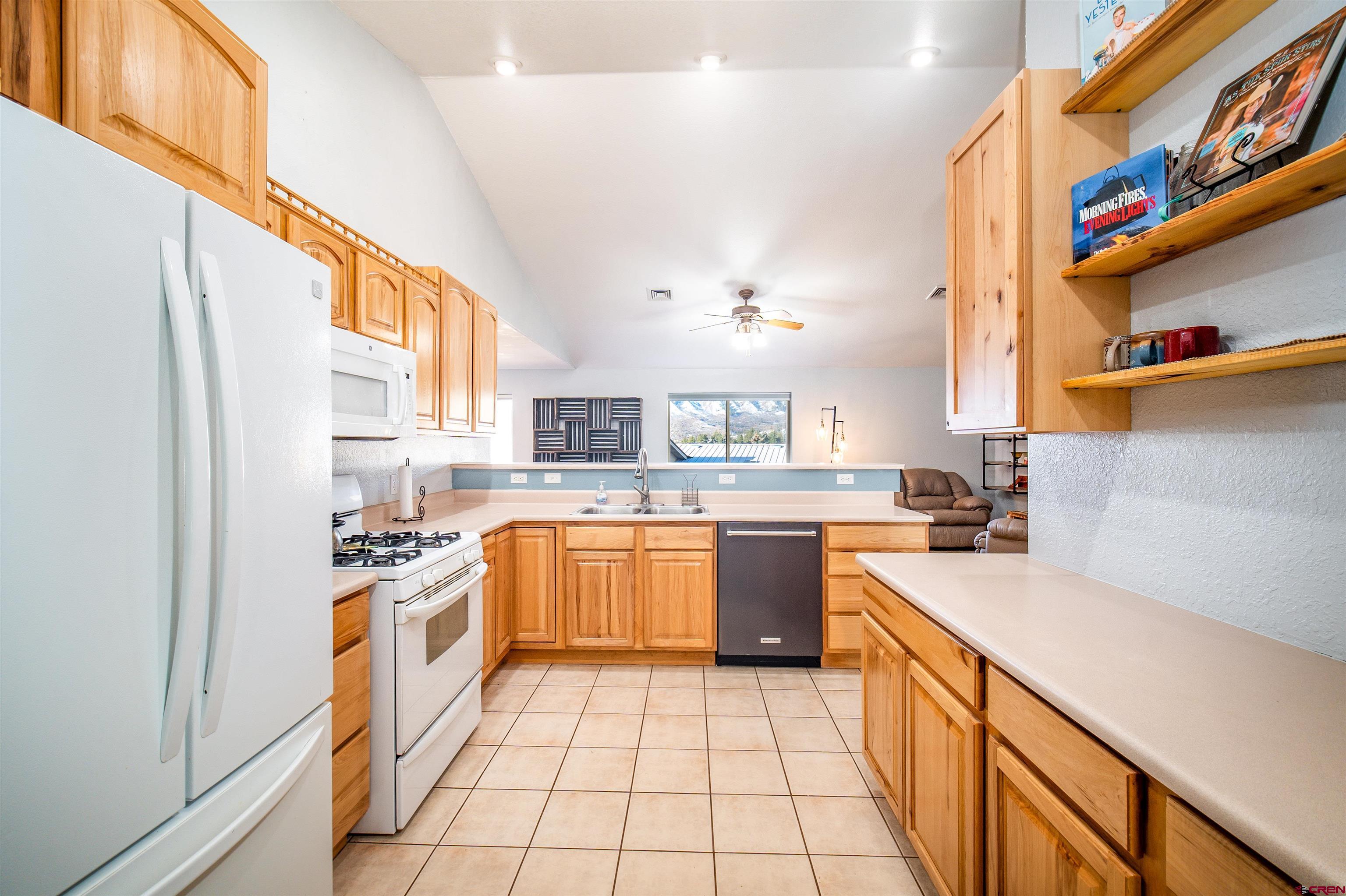 111 Meadowbrook Drive Bayfield, CO 81122 - Photo 4 of 30 a kitchen with stainless steel appliances granite countertop a sink and a refrigerator