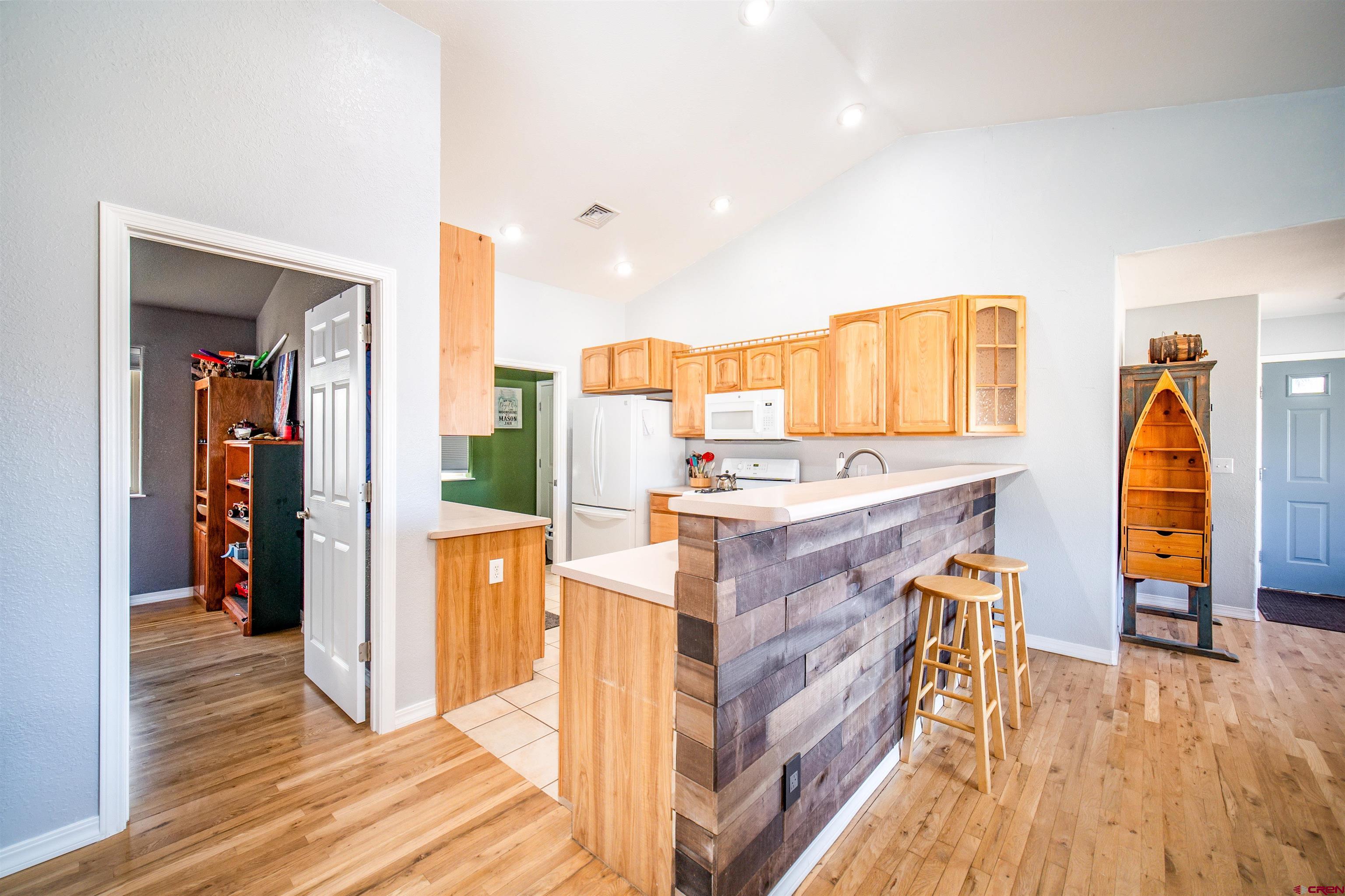 111 Meadowbrook Drive Bayfield, CO 81122 - Photo 5 of 30 a view of kitchen and hall with wooden floor