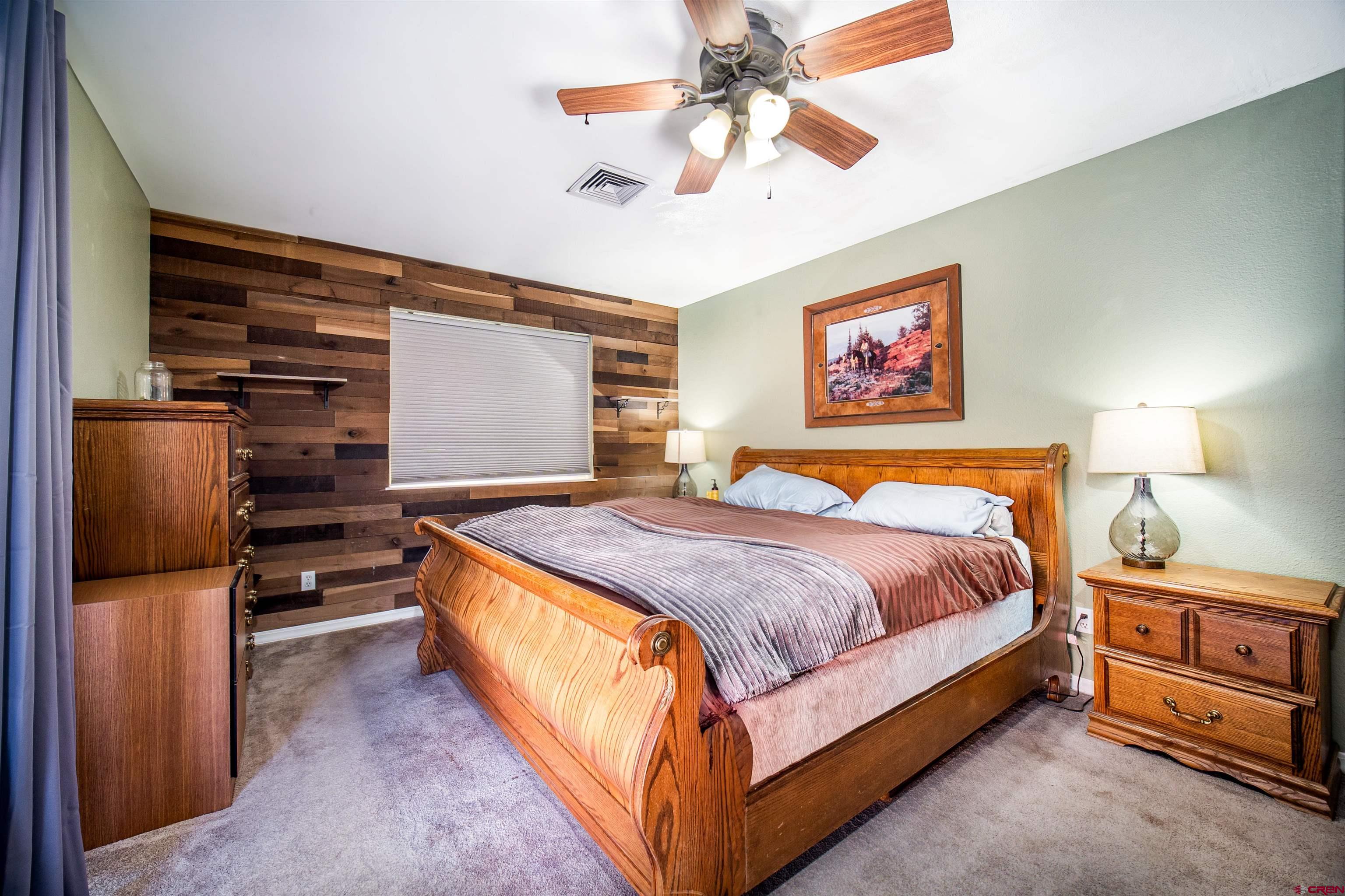 111 Meadowbrook Drive Bayfield, CO 81122 - Photo 10 of 30 a bedroom with a bed and a chandelier