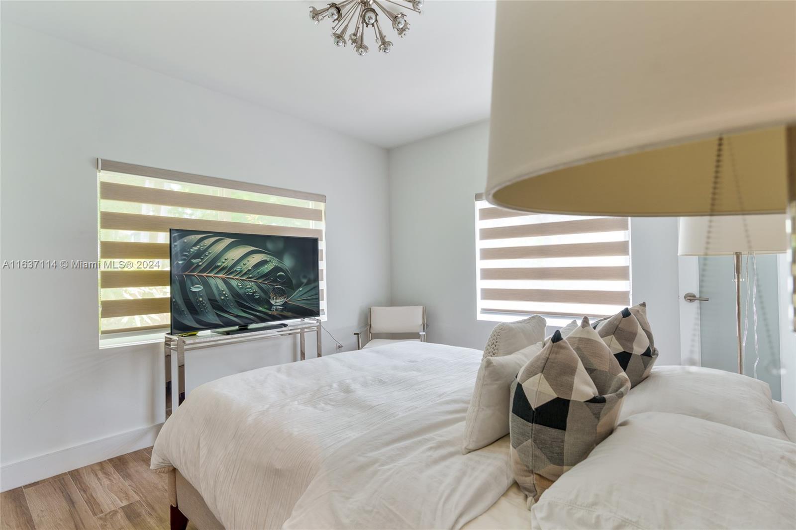 216 Southwest 29th Road Miami, FL 33129 - Photo 16 of 33 a bedroom with a bed and a flat screen tv