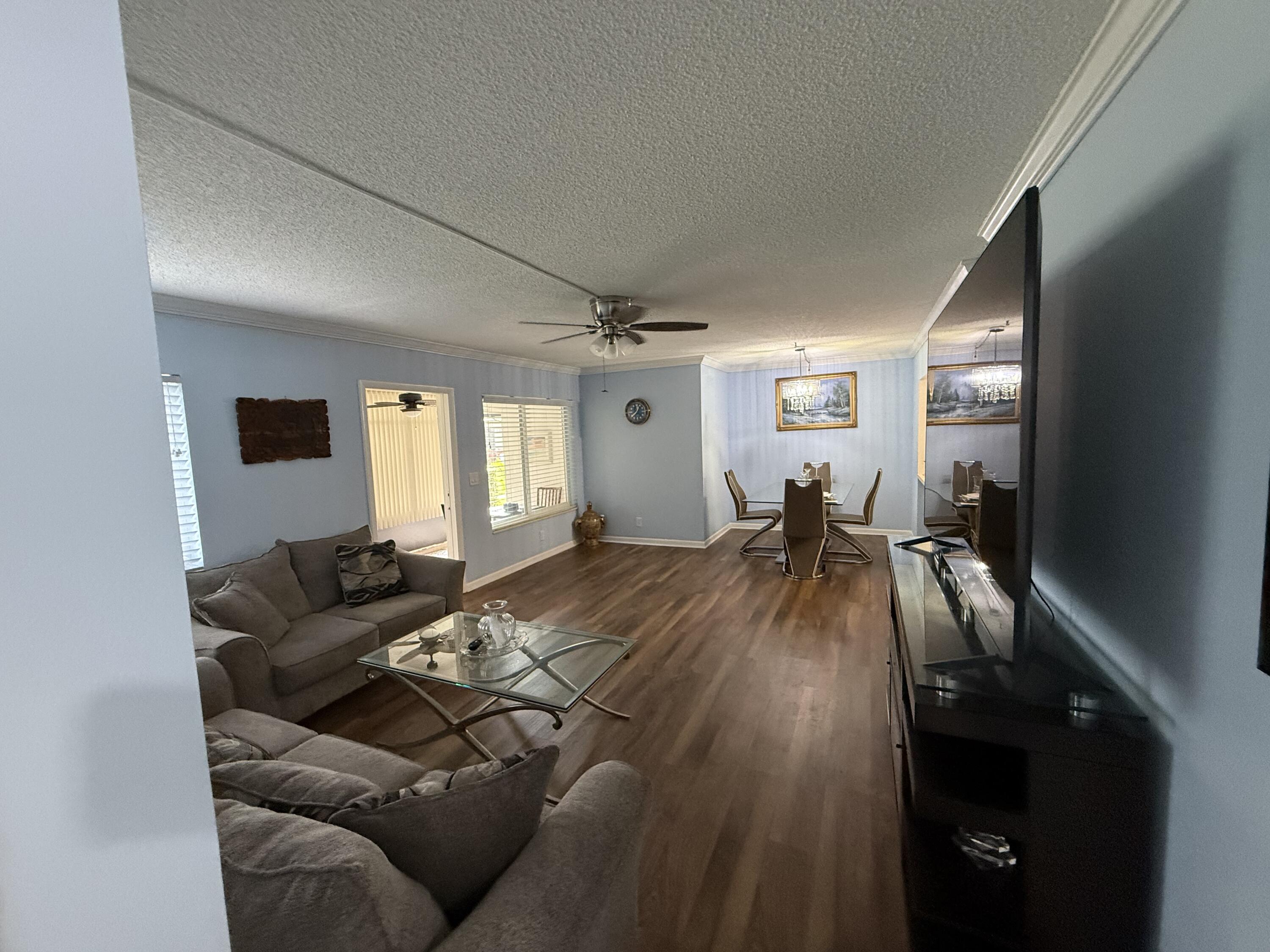 301 Pine Ridge Circle, Unit B1 Greenacres, FL 33463 - Photo 12 of 12 a living room with furniture and a flat screen tv