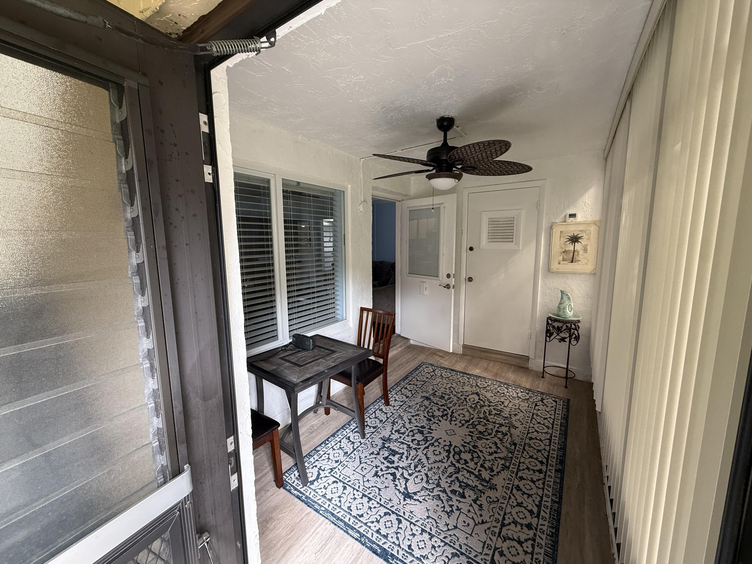301 Pine Ridge Circle, Unit B1 Greenacres, FL 33463 - Photo 2 of 12 a living room with furniture and a rug