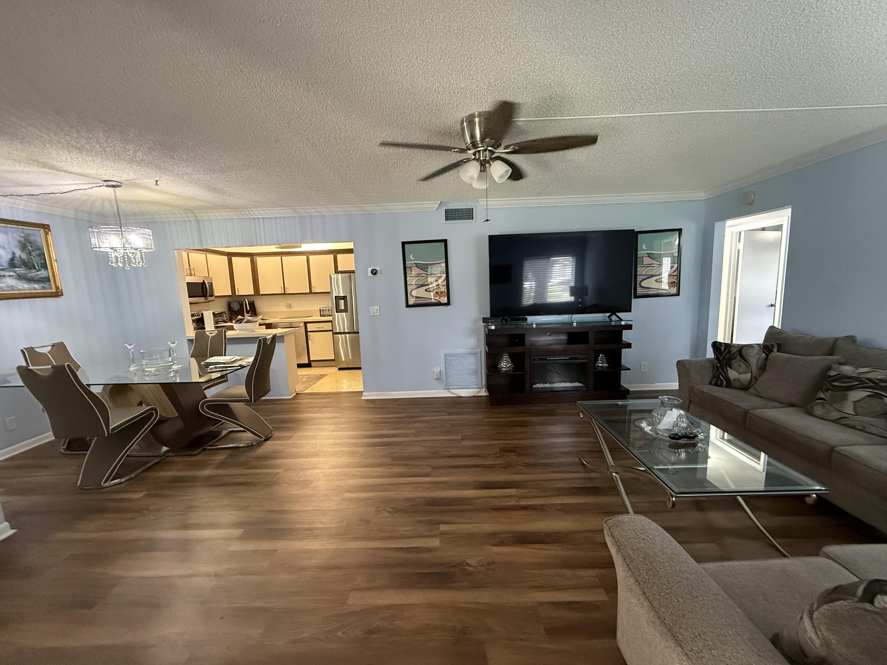 301 Pine Ridge Circle, Unit B1 Greenacres, FL 33463 - Photo 3 of 12 a living room with furniture and a flat screen tv