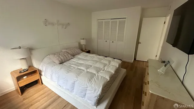 a bed sitting in a bedroom next to a window