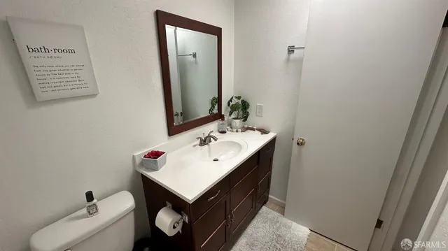 a bathroom with a sink toilet and mirror
