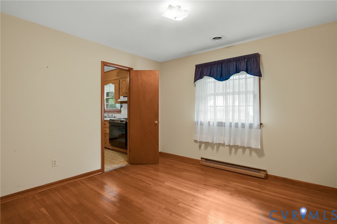 6450 Holborn Road Richmond, VA 23224 - Photo 13 of 20 Spare room featuring a baseboard heating unit and