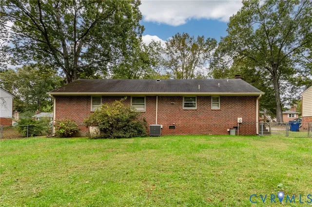 a front view of house with yard and trees