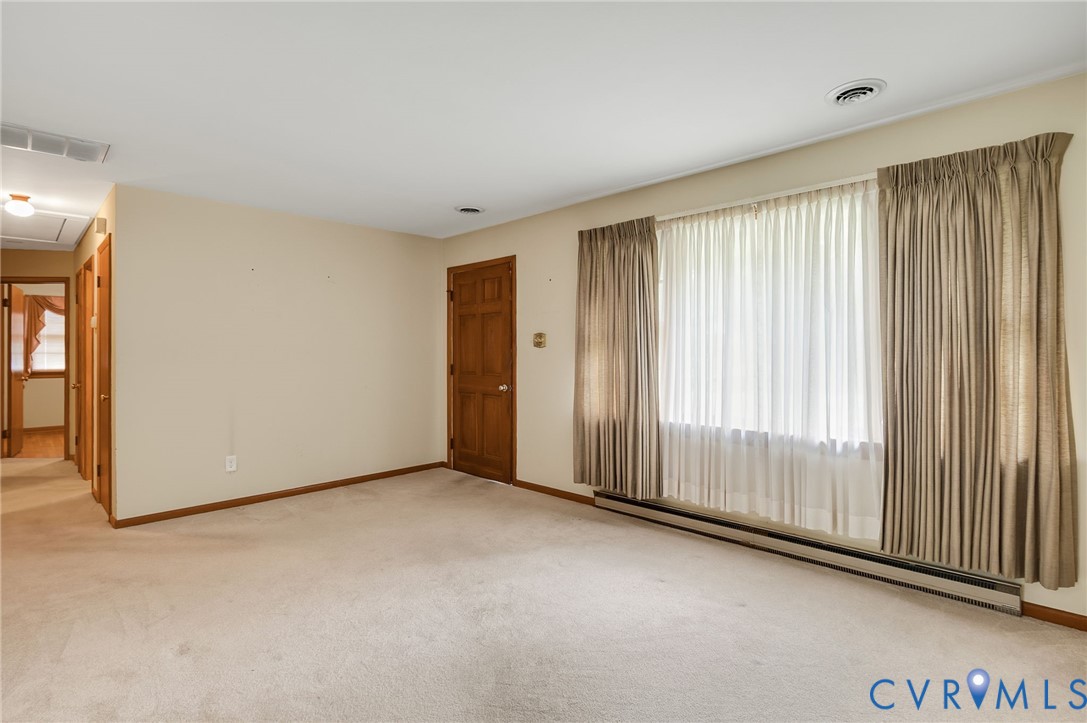 6450 Holborn Road Richmond, VA 23224 - Photo 4 of 20 Spare room with baseboard heating, light colored c