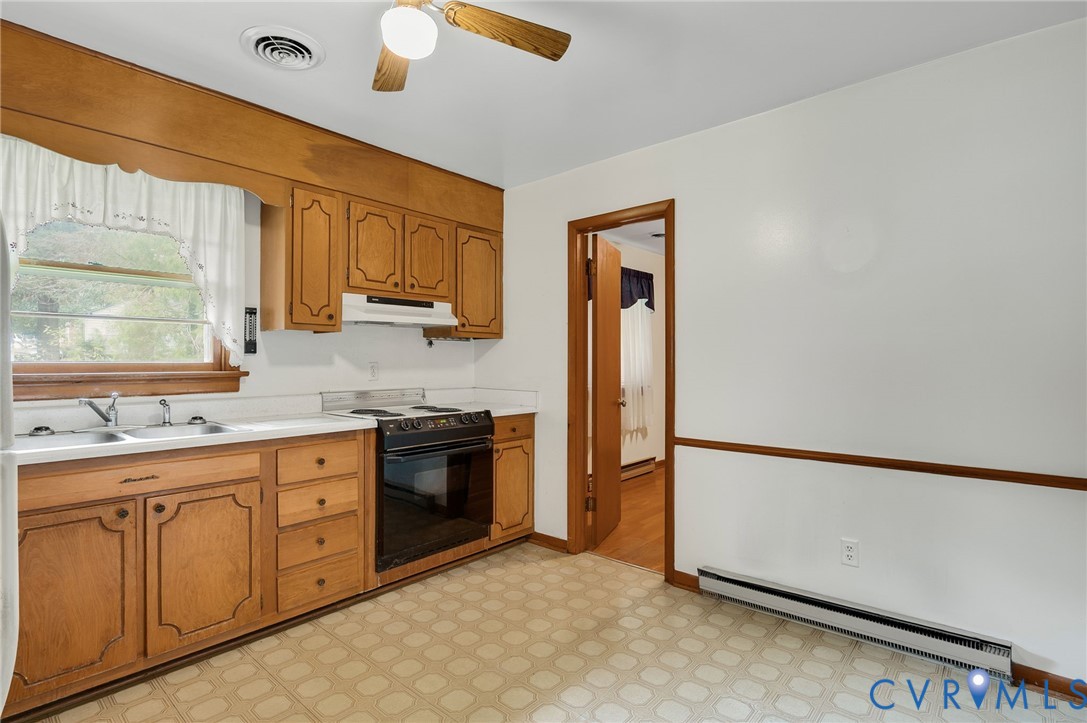 6450 Holborn Road Richmond, VA 23224 - Photo 5 of 20 Kitchen featuring light countertops, baseboard hea