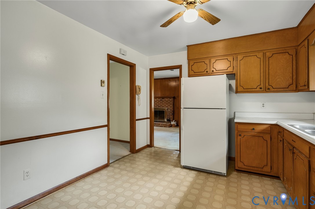 6450 Holborn Road Richmond, VA 23224 - Photo 6 of 20 Kitchen with freestanding refrigerator, brown cabi
