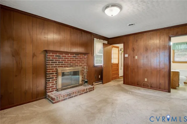 an empty room with fireplace and windows
