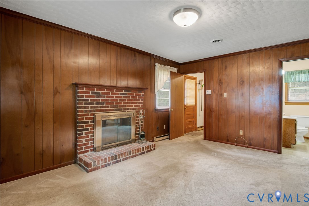 6450 Holborn Road Richmond, VA 23224 - Photo 9 of 20 Unfurnished living room with wooden walls, crown m