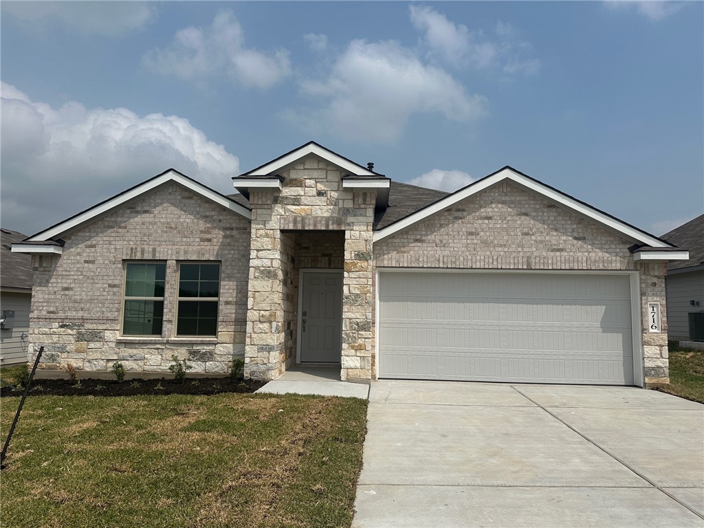 View of front of property with a front lawn, an at