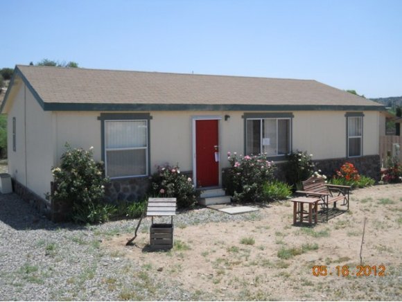 5225 Old Fort Road Rimrock, AZ 86335 - Photo 1 of 6 a view of a house with backyard and sitting area