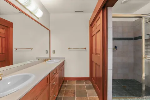 a bathroom with a double vanity sink and mirror