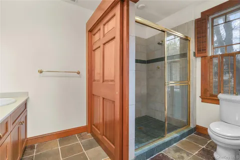 a bathroom with a glass shower door