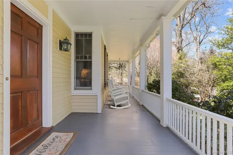 a view of a balcony with wooden floor