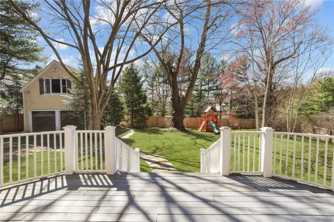a view of a house with a wooden fence