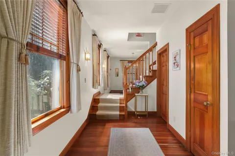 a view of an entryway with wooden floor and stairs
