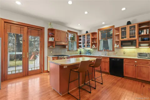 a kitchen with stainless steel appliances granite countertop a stove a sink dishwasher and a refrigerator