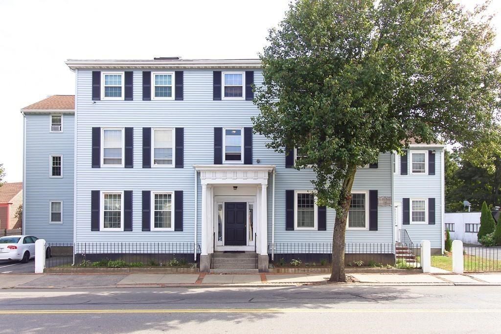 75 Cabot Street, Unit 13 Beverly, MA 01915 - Photo 1 of 13 a house that has a tree in front of it