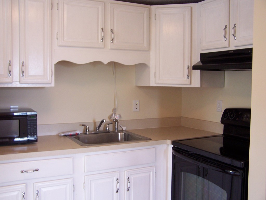 75 Cabot Street, Unit 13 Beverly, MA 01915 - Photo 5 of 13 a kitchen with granite countertop white cabinets and a sink