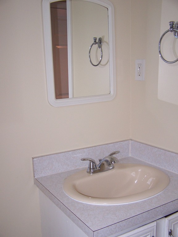 75 Cabot Street, Unit 13 Beverly, MA 01915 - Photo 6 of 13 a bathroom with a sink and a mirror