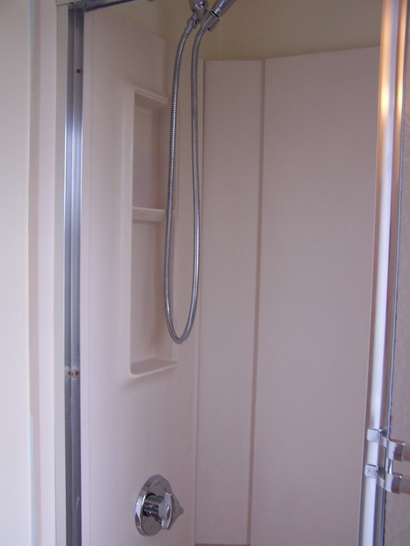 75 Cabot Street, Unit 13 Beverly, MA 01915 - Photo 7 of 13 a bathroom with a glass shower door