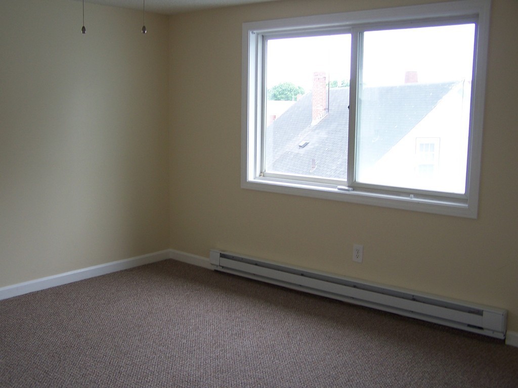 75 Cabot Street, Unit 13 Beverly, MA 01915 - Photo 9 of 13 an empty room with a window