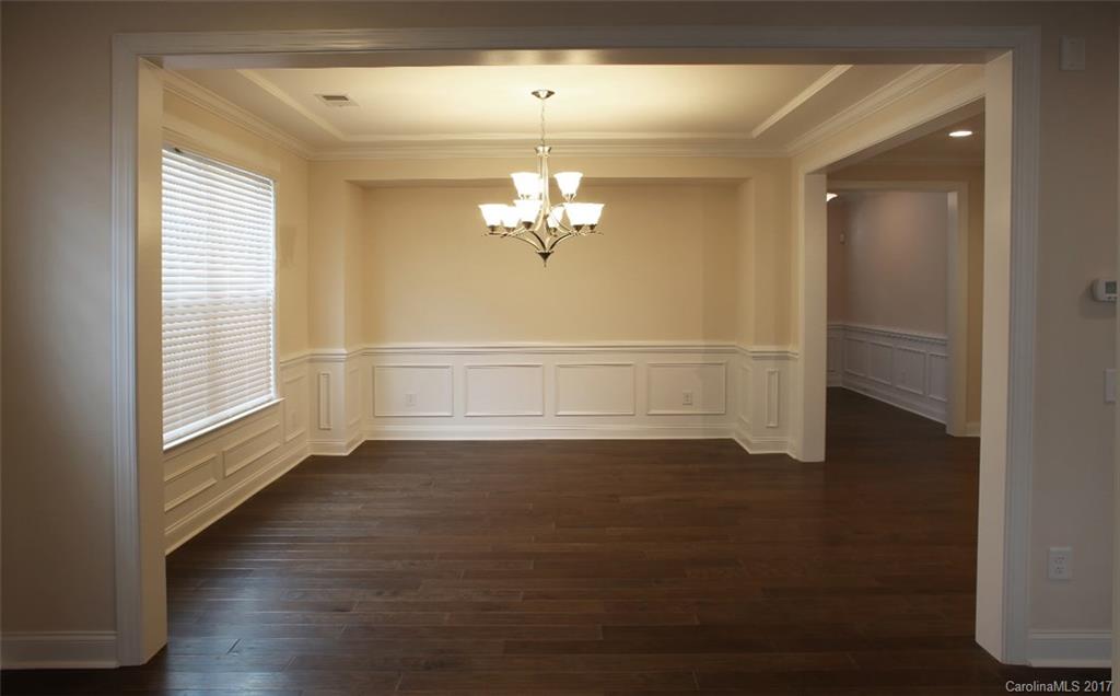 980 Emory Lane, Unit 112 Fort Mill, SC 29708 - Photo 12 of 23 a view of a livingroom with wooden floor a ceiling fan and windows