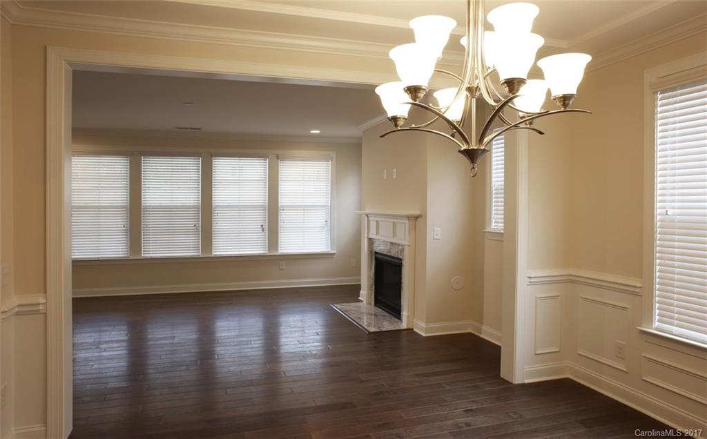 980 Emory Lane, Unit 112 Fort Mill, SC 29708 - Photo 14 of 23 a view of a livingroom with wooden floor a chandelier and a window