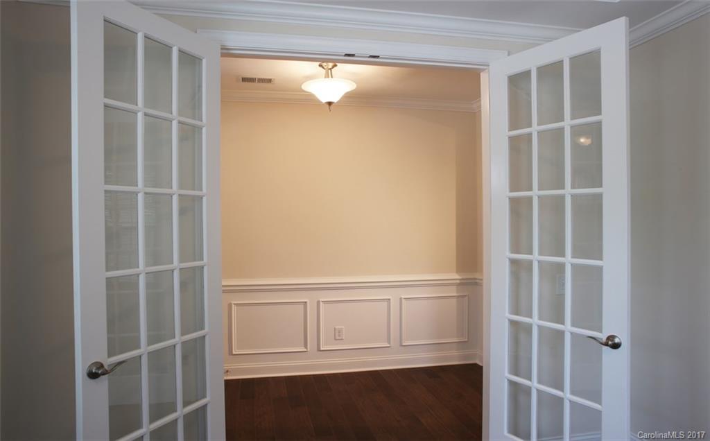 980 Emory Lane, Unit 112 Fort Mill, SC 29708 - Photo 15 of 23 a view of an empty room with wooden floor and cabinet