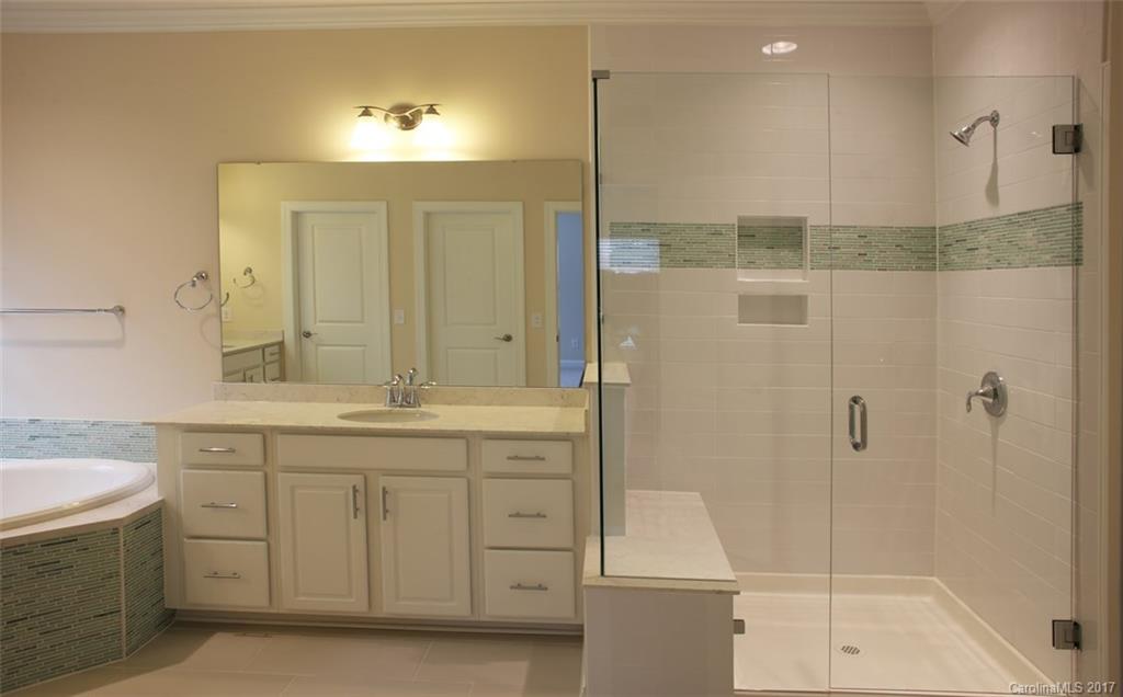 980 Emory Lane, Unit 112 Fort Mill, SC 29708 - Photo 18 of 23 a bathroom with a shower sink and mirror