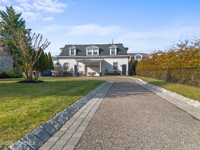 a view of a house with a big yard and large trees