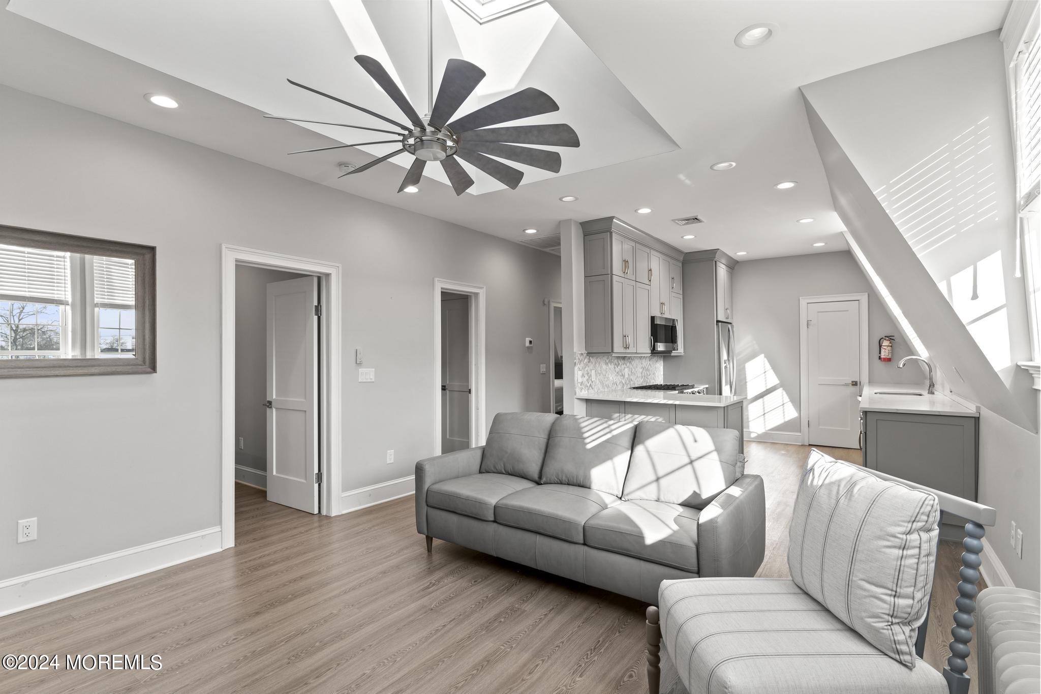 892 Elberon Avenue Long Branch, NJ 07740 - Photo 13 of 50 a living room with furniture and a wooden floor