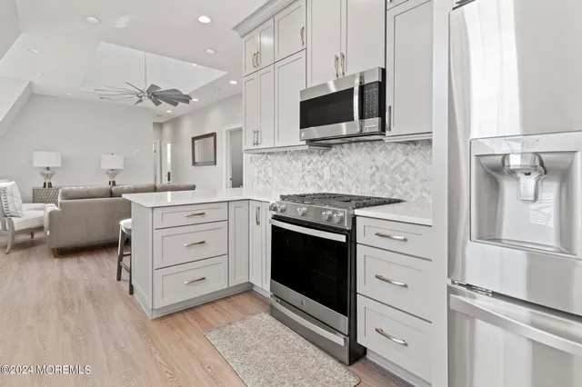 a front view of multiple houses with yard