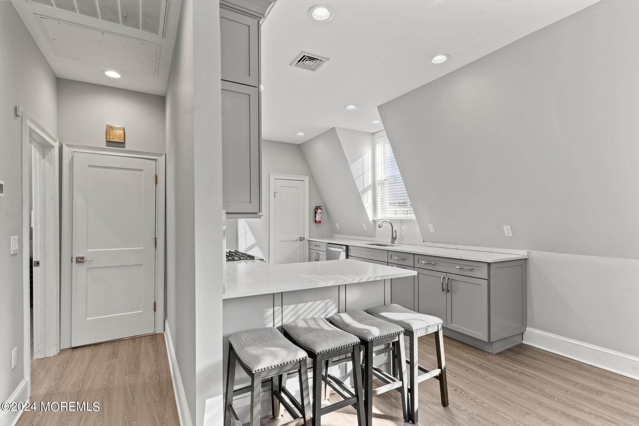 892 Elberon Avenue Long Branch, NJ 07740 - Photo 15 of 50 a view of a kitchen area with furniture and wooden floor