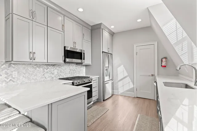 a stove top oven sitting inside of a kitchen